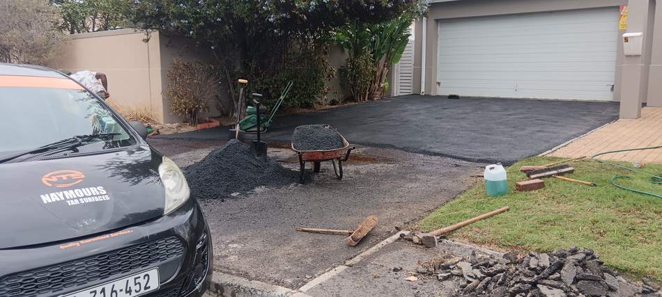 The Naymours Tar Surfaces branded vehicle on site during a driveway tarring job