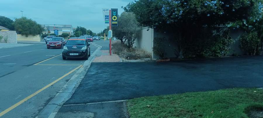 Kerb lowering and new tar pavement crossing at a bus stop