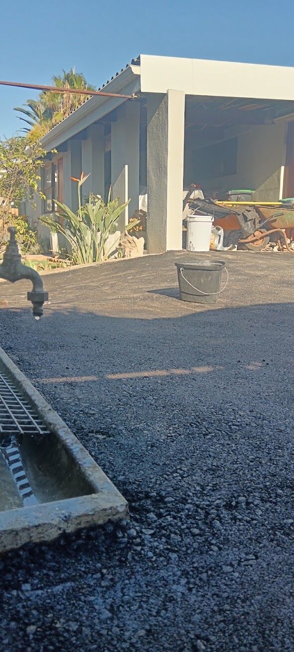 Fresh asphalt laid neatly around a drain grate