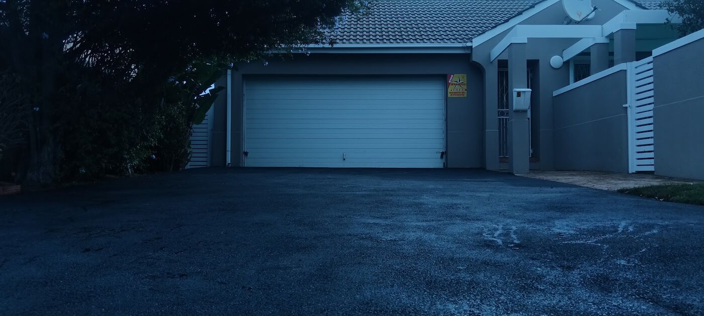 Fresh tar surface at a garage entrance