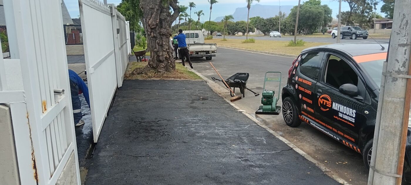 Naymours Tar Surfaces branded vehicle and roller at a completed job