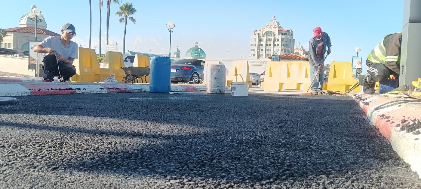 Close-up of compacted asphalt surface at a commercial site
