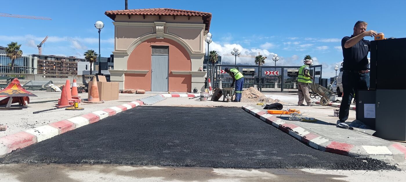 Freshly tarred traffic island with painted kerbs