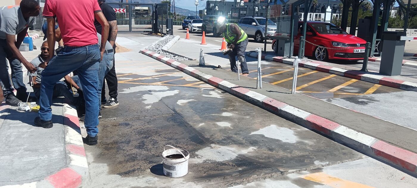 Team painting red and white kerb markings