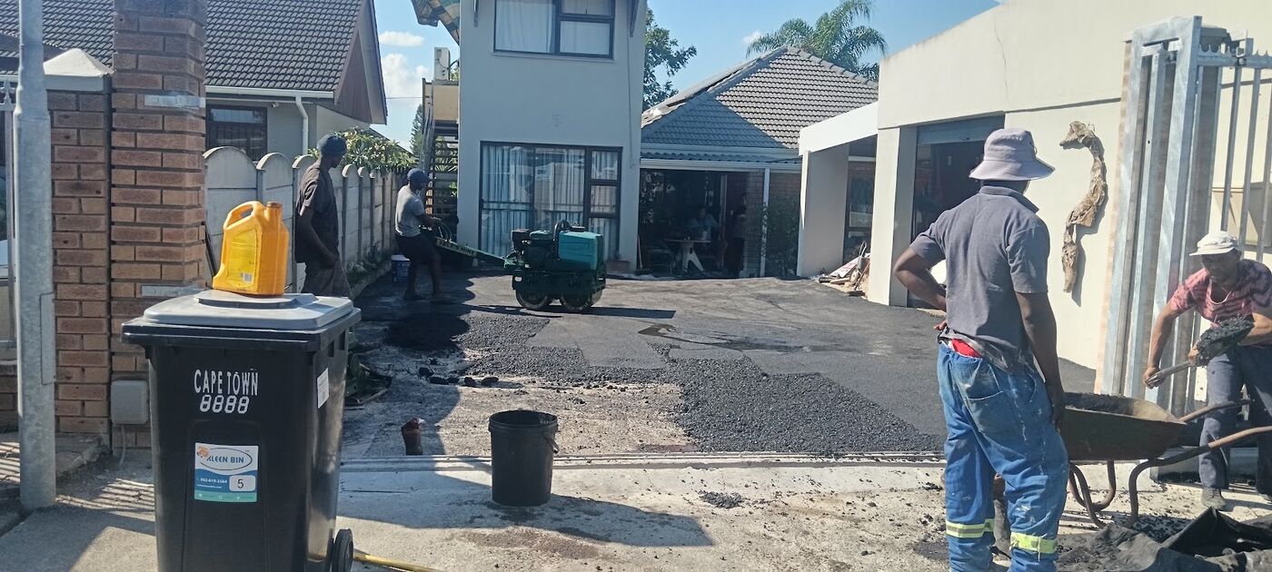 Team laying hot asphalt on a residential driveway