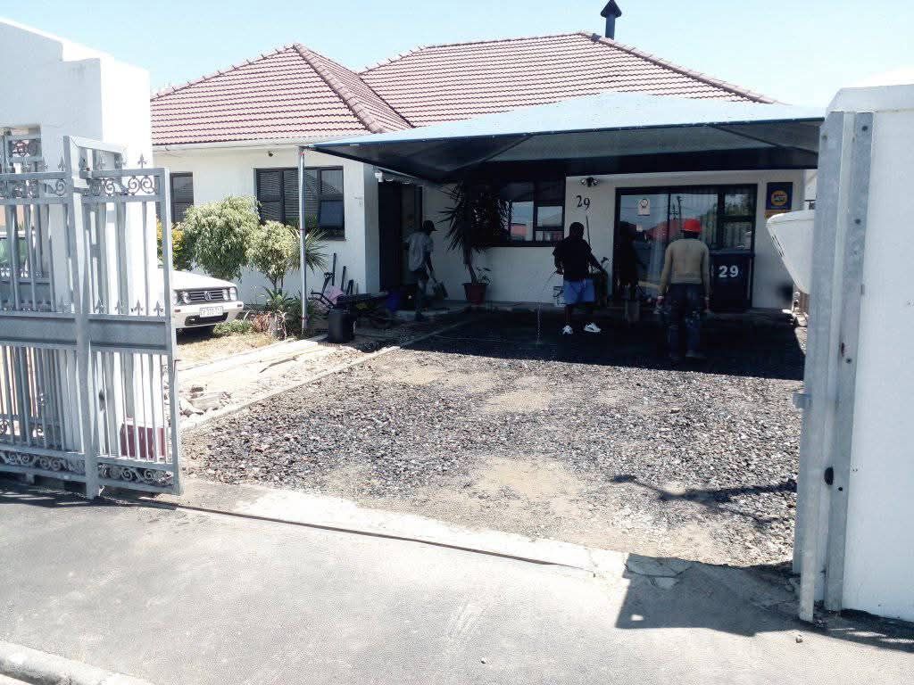 Compacted gravel base prepared at a home before tarring