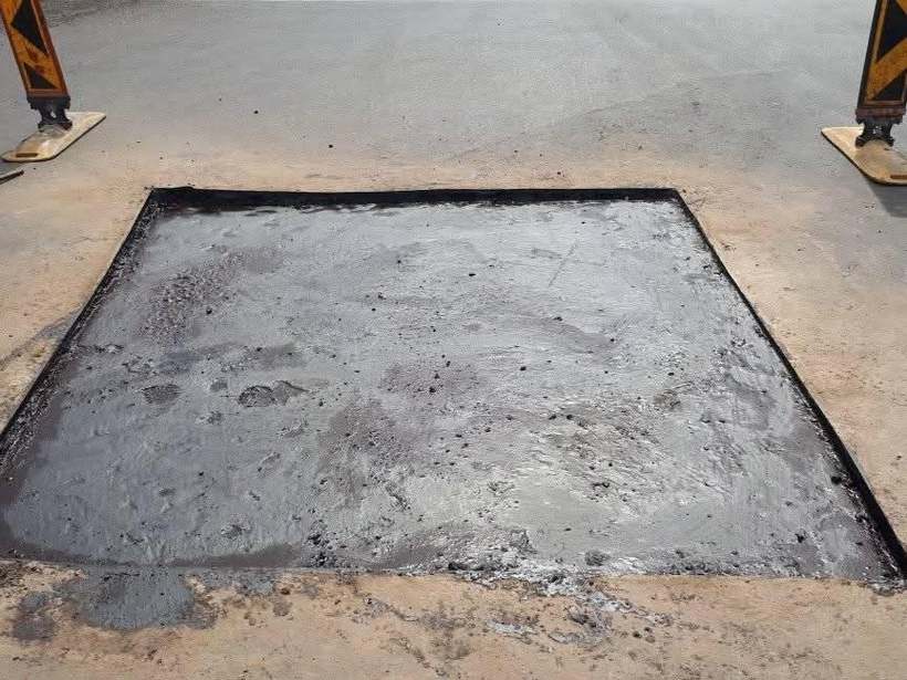 Sealed black asphalt patch repair completed on the same spot