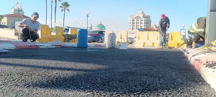 Team compacting and finishing the new asphalt surface