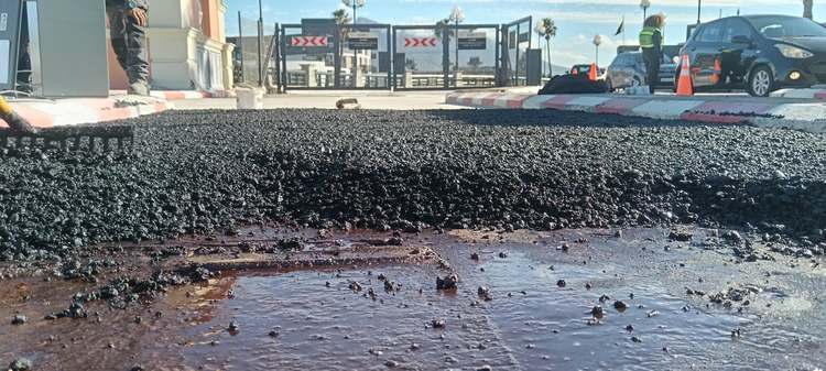 Hot asphalt being raked and levelled